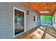 Spacious covered front porch featuring a wooden ceiling with skylight and wooded views at 1715 Us 15-501 S, Chapel Hill, NC 27517