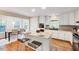 Bright kitchen with granite countertops, white cabinetry, stainless appliances, and a cozy breakfast nook at 1715 Us 15-501 S, Chapel Hill, NC 27517