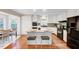 Charming kitchen with a granite island, white cabinets, wood floors, and stainless steel appliances at 1715 Us 15-501 S, Chapel Hill, NC 27517