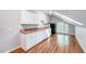 Small kitchenette with white cabinets, warm toned counters, mini-fridge, and skylight at 1715 Us 15-501 S, Chapel Hill, NC 27517