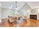 Bright living room with vaulted ceilings, skylights, fireplace, and hardwood flooring at 1715 Us 15-501 S, Chapel Hill, NC 27517