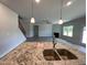 Kitchen featuring an island, granite countertops, and a view of the open-concept living room with a fireplace at 1737 Pecan Drive # 21, Nashville, NC 27856