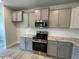 Kitchen featuring granite countertops, stainless steel appliances, and gray cabinetry at 1737 Pecan Drive # 21, Nashville, NC 27856