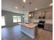 Modern kitchen boasts stainless steel appliances, light gray cabinetry, granite countertops, and an island at 1737 Pecan Drive # 21, Nashville, NC 27856