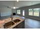 A living room adjacent to the kitchen, showcasing its fireplace, windows, and access to the backyard at 1737 Pecan Drive # 21, Nashville, NC 27856