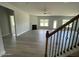 A view from the top of the stairs overlooking the open-concept living area with a fireplace and ample natural light at 1737 Pecan Drive # 21, Nashville, NC 27856