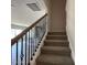 Carpeted staircase featuring a modern black iron railing with decorative wooden accents at 1737 Pecan Drive # 21, Nashville, NC 27856