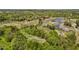 Aerial view of houses in a golf community, highlighting mature trees and serene water features at 2066 Lake Point Dr, Graham, NC 27253