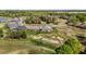 Aerial view of homes nestled in golf course community with scenic fairways and mature trees at 2066 Lake Point Dr, Graham, NC 27253