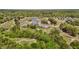 Scenic aerial view of houses in a golf community, showcasing well-maintained landscaping and a pond at 2066 Lake Point Dr, Graham, NC 27253