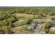 Picturesque aerial of a golf course community with elegant houses, lush trees, and water features at 2066 Lake Point Dr, Graham, NC 27253