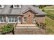 Home's backyard features a brick exterior, a raised patio, and a manicured lawn at 2066 Lake Point Dr, Graham, NC 27253