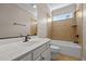 Bathroom features a tub and shower, a window, and white vanity at 2066 Lake Point Dr, Graham, NC 27253