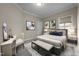 Neutral bedroom featuring a window, a desk, and modern furnishings at 2066 Lake Point Dr, Graham, NC 27253