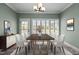 Bright dining room with a modern light fixture, decorative painting, and plantation shutters at 2066 Lake Point Dr, Graham, NC 27253