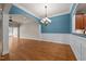 Open-concept dining area featuring hardwood floors and stylish chandelier at 2066 Lake Point Dr, Graham, NC 27253