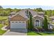 Beautiful stone home with a two-car garage, lush landscaping, and a well-maintained lawn at 2066 Lake Point Dr, Graham, NC 27253
