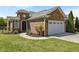 Charming brick home with manicured lawn, arched entry, and two car garage at 2066 Lake Point Dr, Graham, NC 27253