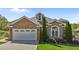 Charming stone home featuring a two-car garage and meticulously manicured landscaping at 2066 Lake Point Dr, Graham, NC 27253