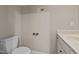 A small half bathroom featuring a white toilet, single sink and neutral wall color at 2066 Lake Point Dr, Graham, NC 27253