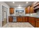 Spacious kitchen with dark wood cabinetry, tile backsplash, and stainless steel appliances at 2066 Lake Point Dr, Graham, NC 27253