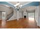 Spacious living room with hardwood floors, fireplace, staircase and ample natural light at 2066 Lake Point Dr, Graham, NC 27253