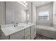 Bright bathroom with double sinks and a bathtub underneath a window at 209 Timber Forest Ln, Cary, NC 27519