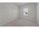 A cozy secondary bedroom with neutral carpet, paint and a large window at 209 Timber Forest Ln, Cary, NC 27519
