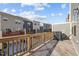 View from wooden deck shows townhome exteriors against a bright blue sky at 209 Timber Forest Ln, Cary, NC 27519
