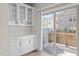 Bright dining area with white cabinets, a sliding glass door to the back deck, and hardwood floors at 209 Timber Forest Ln, Cary, NC 27519