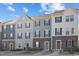 Charming townhomes featuring stone accents, neutral color palettes, and well-maintained landscaping at 209 Timber Forest Ln, Cary, NC 27519