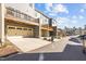 Street view of townhomes with garages and balconies shows design and landscaping at 209 Timber Forest Ln, Cary, NC 27519