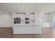 Contemporary kitchen with large center island, stainless steel appliances, and white cabinetry at 209 Timber Forest Ln, Cary, NC 27519