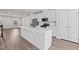Modern kitchen boasts an island with quartz countertops and stainless steel appliances at 209 Timber Forest Ln, Cary, NC 27519