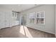 Cozy living room with a sliding glass door, a built-in cabinet, hardwood floors, and large windows at 209 Timber Forest Ln, Cary, NC 27519