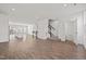 Open-concept living area showcases the kitchen and staircase with wood-look floors at 209 Timber Forest Ln, Cary, NC 27519