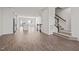 Spacious living room with staircase access and an open view of the modern kitchen at 209 Timber Forest Ln, Cary, NC 27519