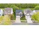 An aerial view of a neighborhood showcasing the home's location amongst tree lined streets and well-manicured lawns at 2103 Glenkirk Dr, Burlington, NC 27215