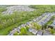 An aerial view of a neighborhood showcasing the home's location amongst lush trees and manicured lawns at 2103 Glenkirk Dr, Burlington, NC 27215