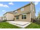 Backyard view of the home featuring a large concrete patio and green lawn at 2103 Glenkirk Dr, Burlington, NC 27215