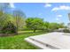Lush backyard with green lawn, mature trees, and a concrete patio at 2103 Glenkirk Dr, Burlington, NC 27215