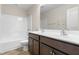 Bathroom features double vanity with dark wood cabinets, and tub with shower at 2103 Glenkirk Dr, Burlington, NC 27215