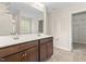 Bathroom with dual sink vanity, tile floor, and walk-in closet access at 2103 Glenkirk Dr, Burlington, NC 27215