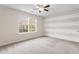 Spacious bedroom with neutral carpet, and a large window overlooking the yard at 2103 Glenkirk Dr, Burlington, NC 27215