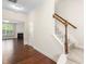 A warm and inviting entryway with hardwood floors and staircase leading to the upper level of the home at 2103 Glenkirk Dr, Burlington, NC 27215