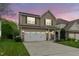 Charming two-story home featuring a two-car garage, neutral siding, well maintained lawn and stone accents on the facade at 2103 Glenkirk Dr, Burlington, NC 27215