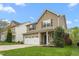 Charming two-story home featuring a two-car garage, neutral siding, well maintained lawn and stone accents on the facade at 2103 Glenkirk Dr, Burlington, NC 27215