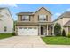 Charming two-story home featuring a two-car garage, neutral siding, well maintained lawn and stone accents on the facade at 2103 Glenkirk Dr, Burlington, NC 27215