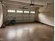 Spacious garage with epoxy flooring, overhead storage, and convenient lawn care equipment at 2103 Glenkirk Dr, Burlington, NC 27215