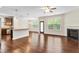 Open-concept living area with hardwood floors, a fireplace and seamless transition to the kitchen and dining spaces at 2103 Glenkirk Dr, Burlington, NC 27215